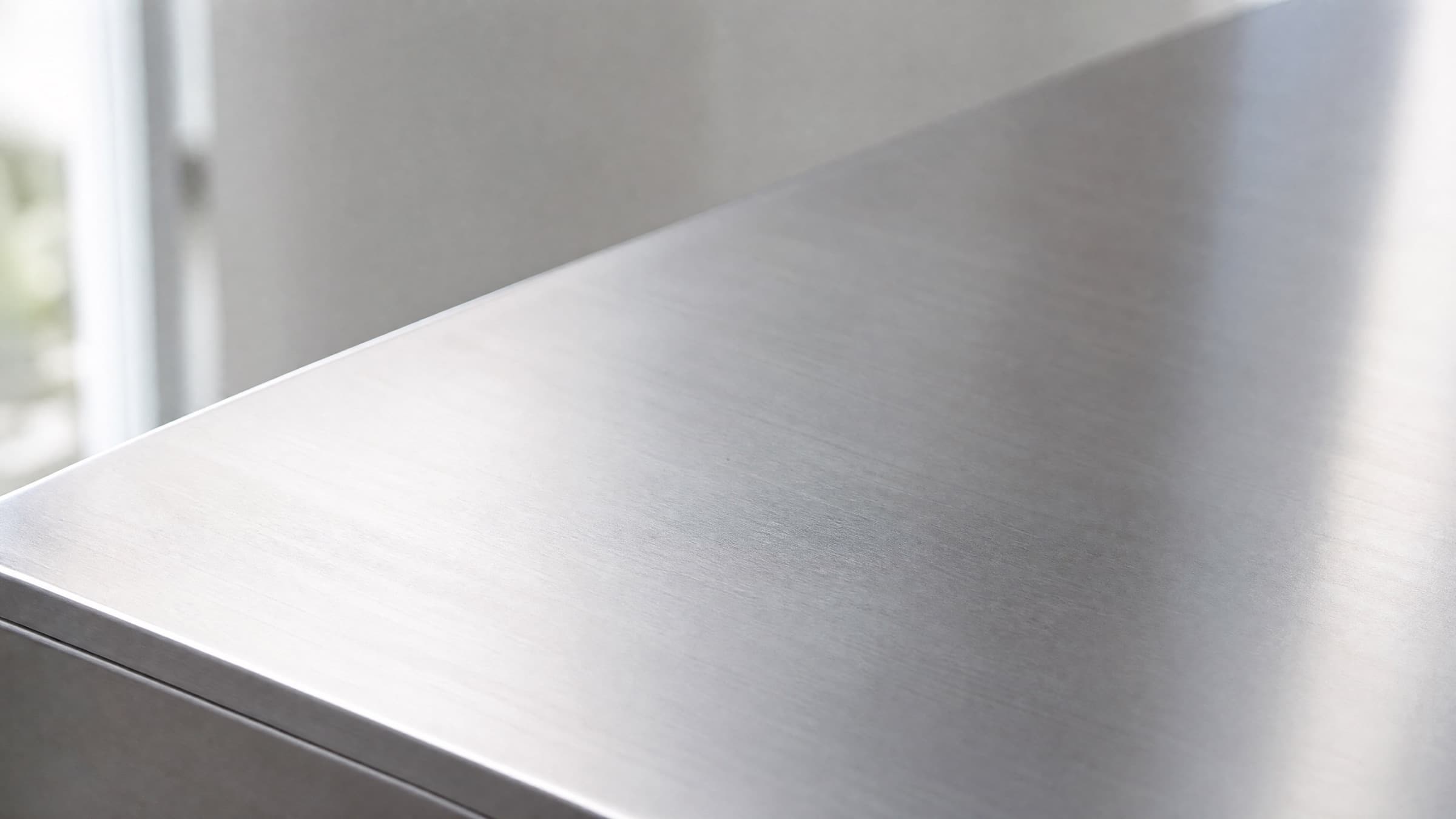 Brushed 2205 stainless steel surface in soft natural light