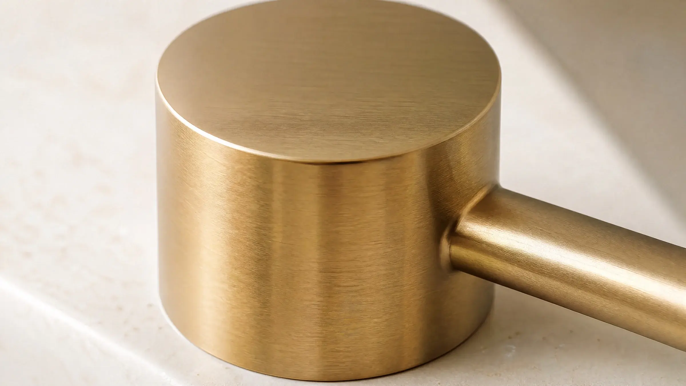 Brushed H65 brass surface in soft natural light