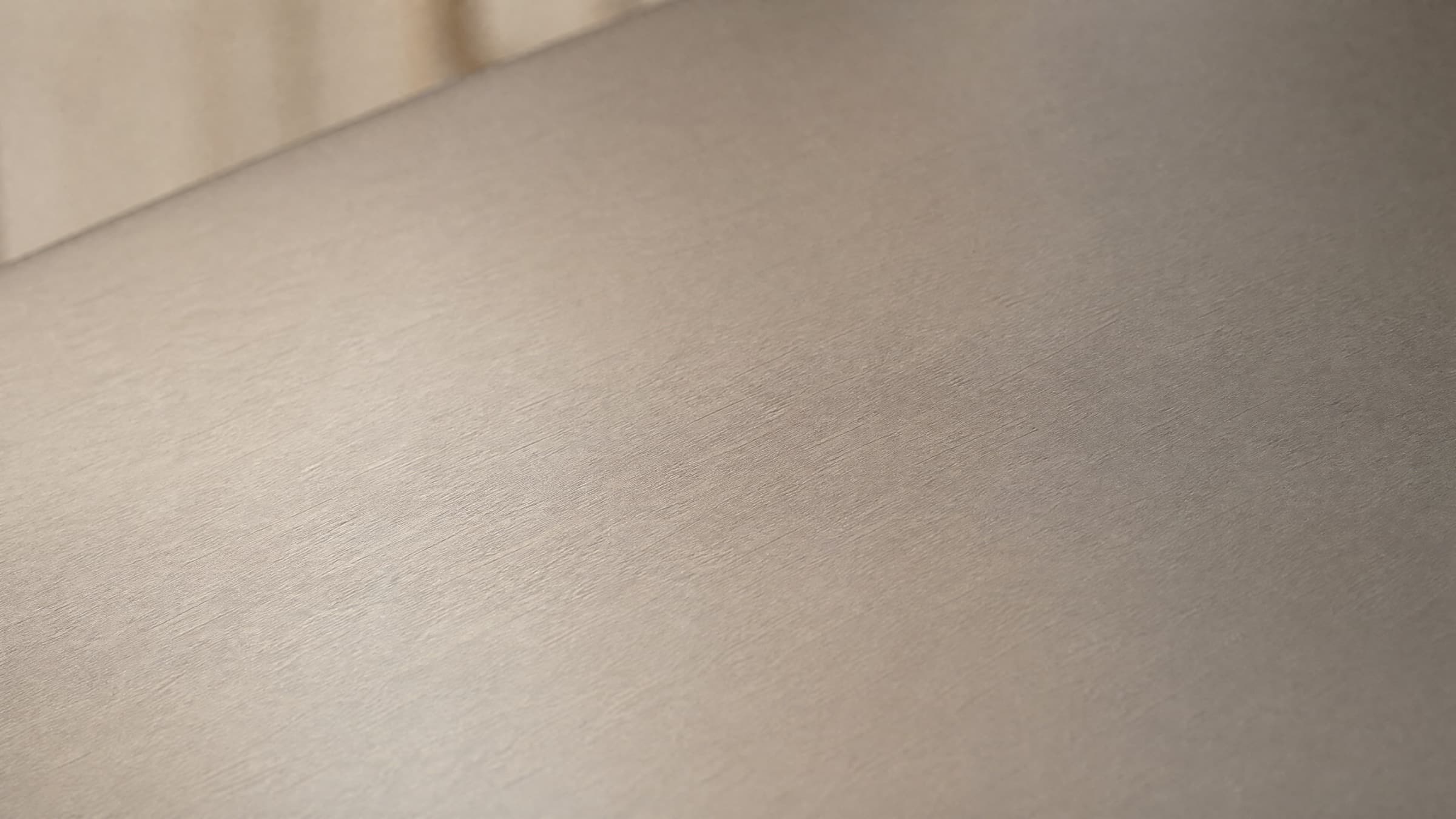 Matte TA2 titanium surface in soft natural light