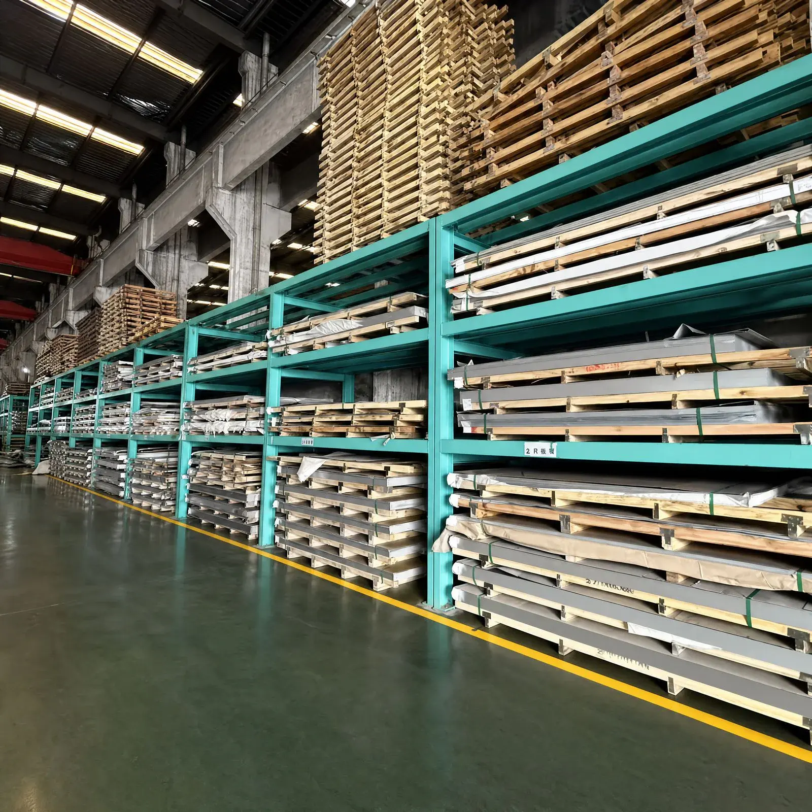 Racked stainless steel sheets and plates in the Steelhui warehouse