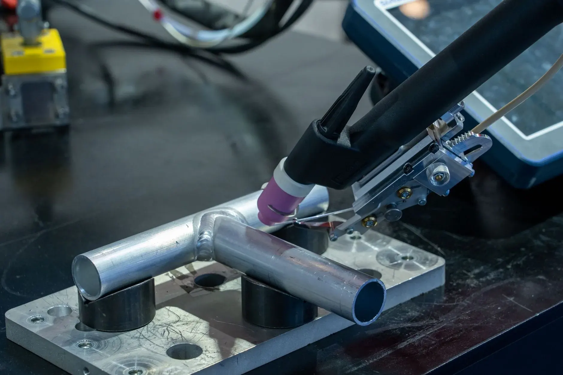 A metal tube is welded before any documented downstream cleaning or surface treatment.