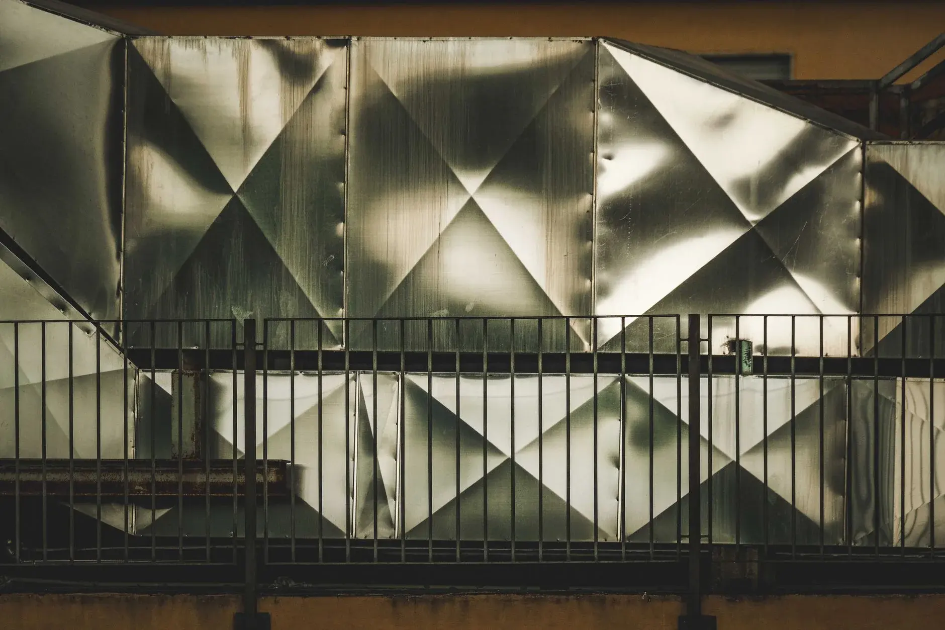 Architectural stainless-steel ventilation panels show how reflection and panel geometry interact.