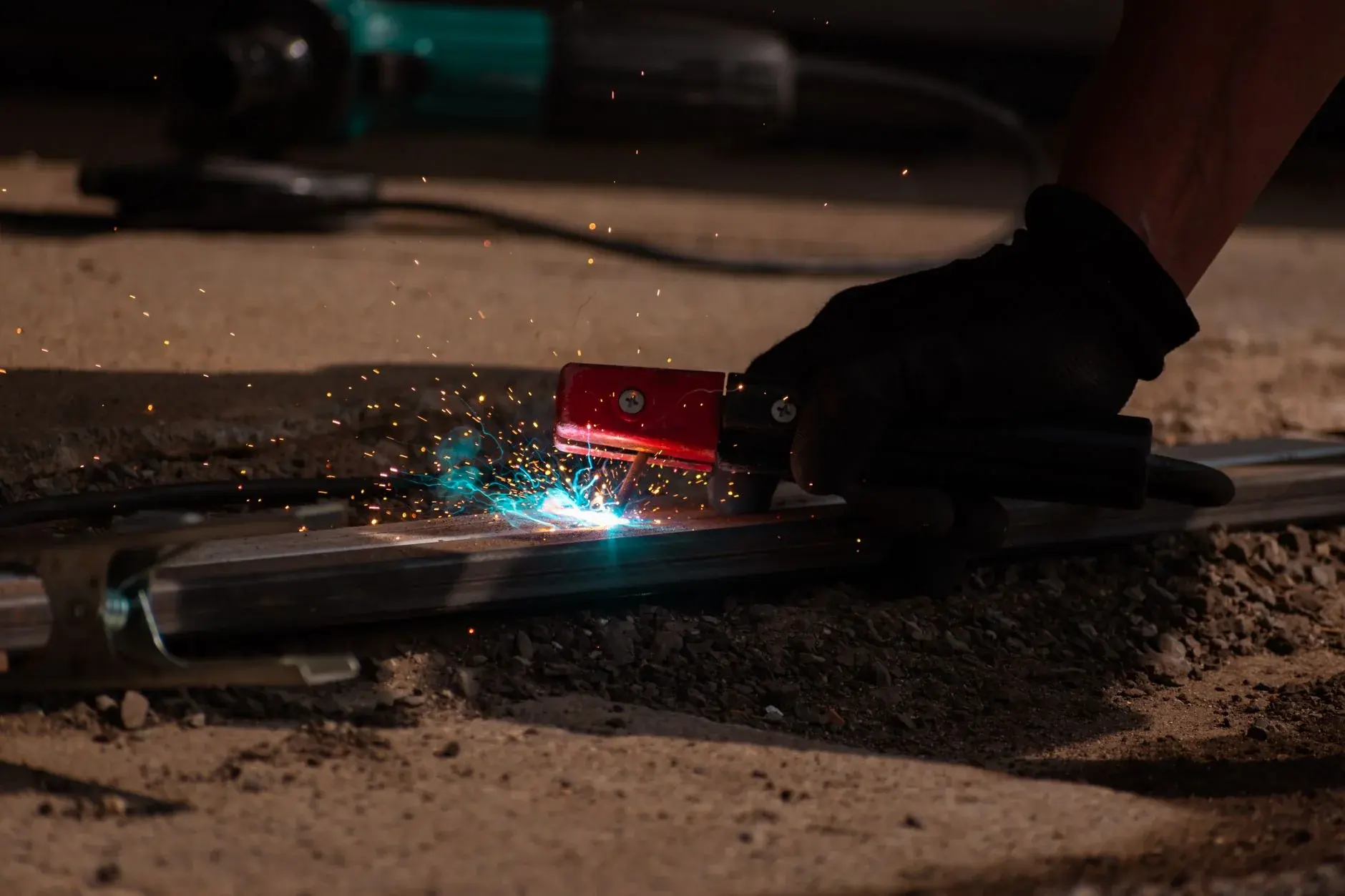 Close-up of a hand-held metalworking operation before final surface inspection.
