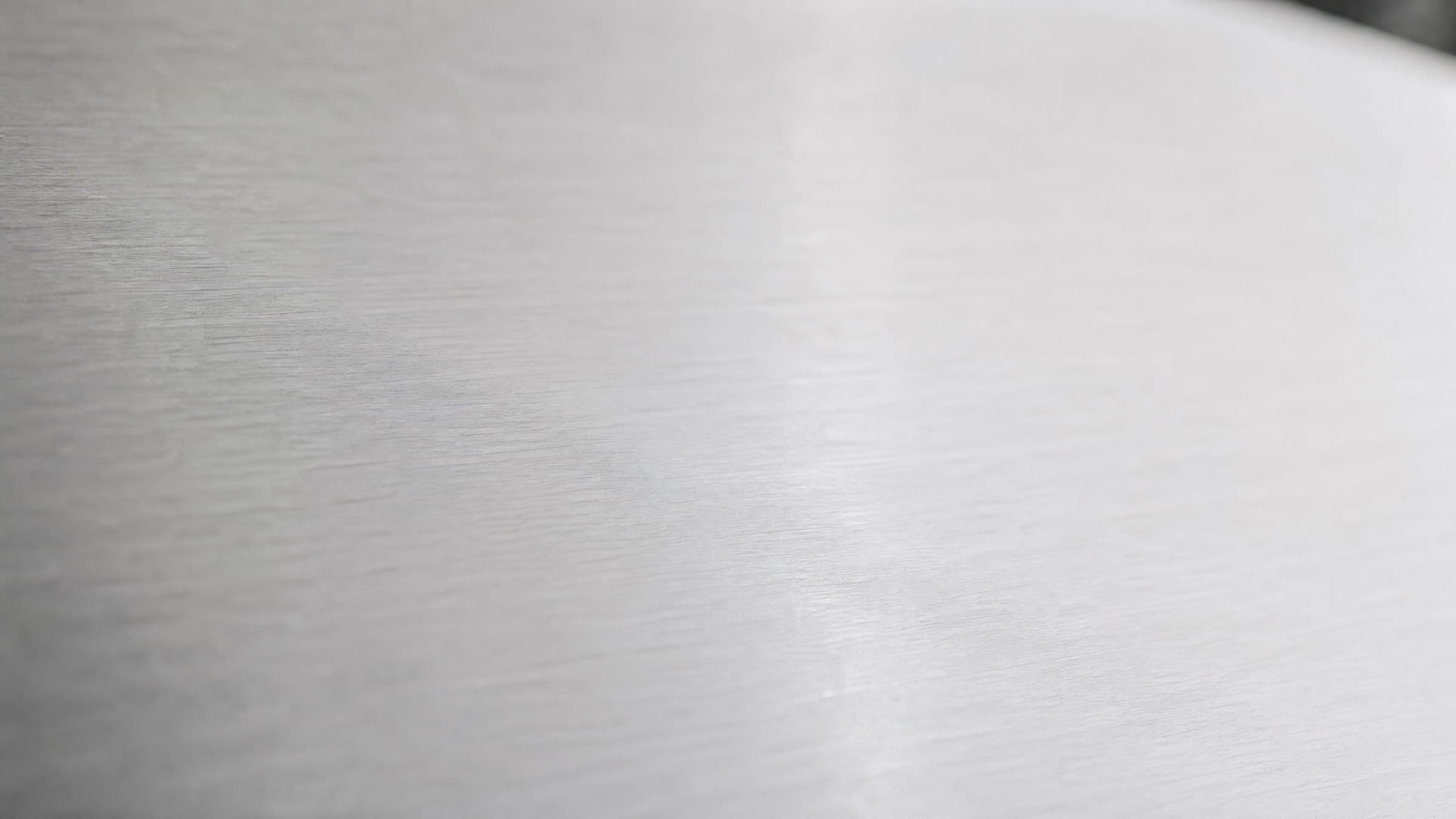 Brushed 1060 aluminium surface in soft natural light
