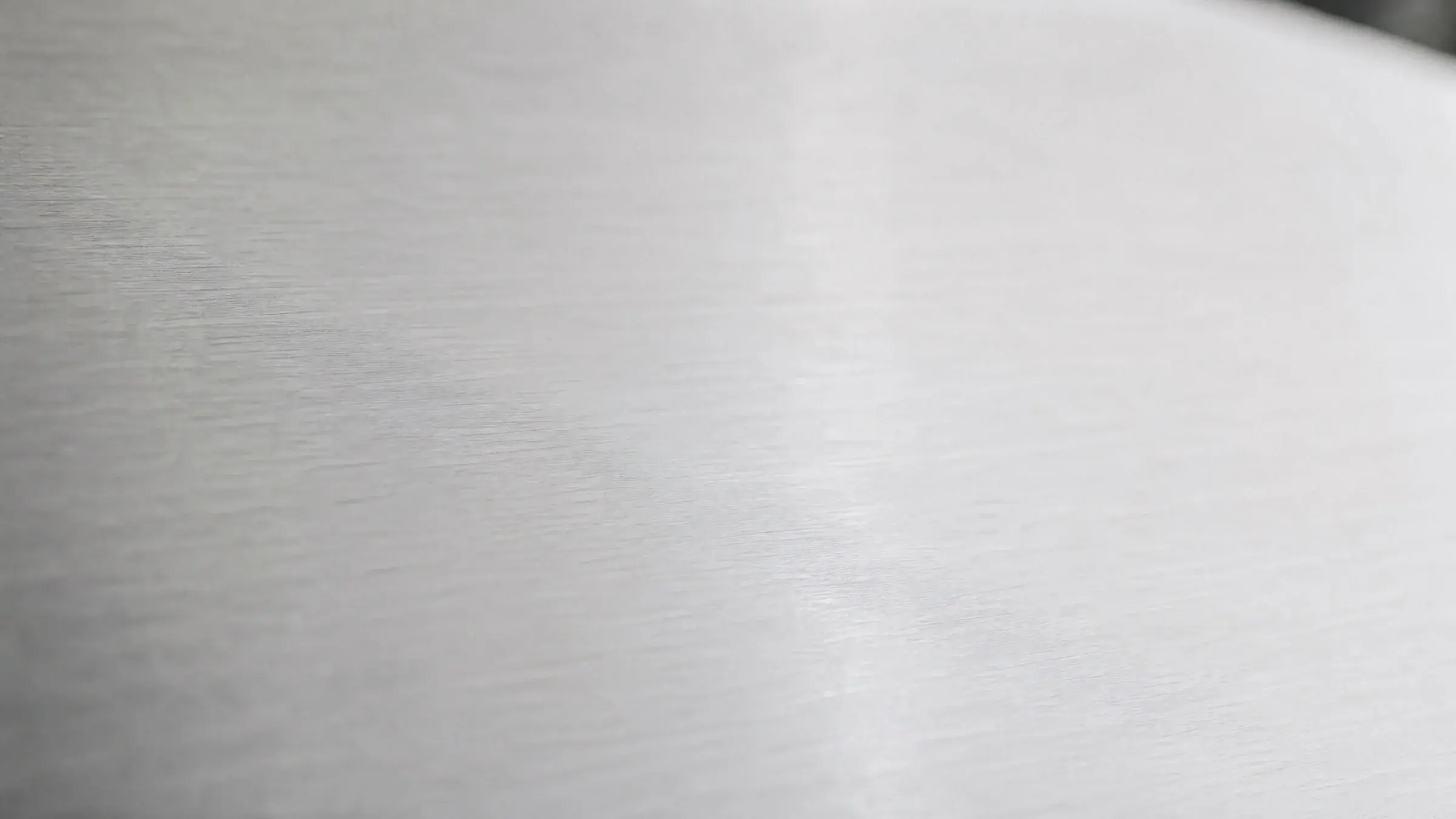 Brushed 1060 aluminium surface in soft natural light