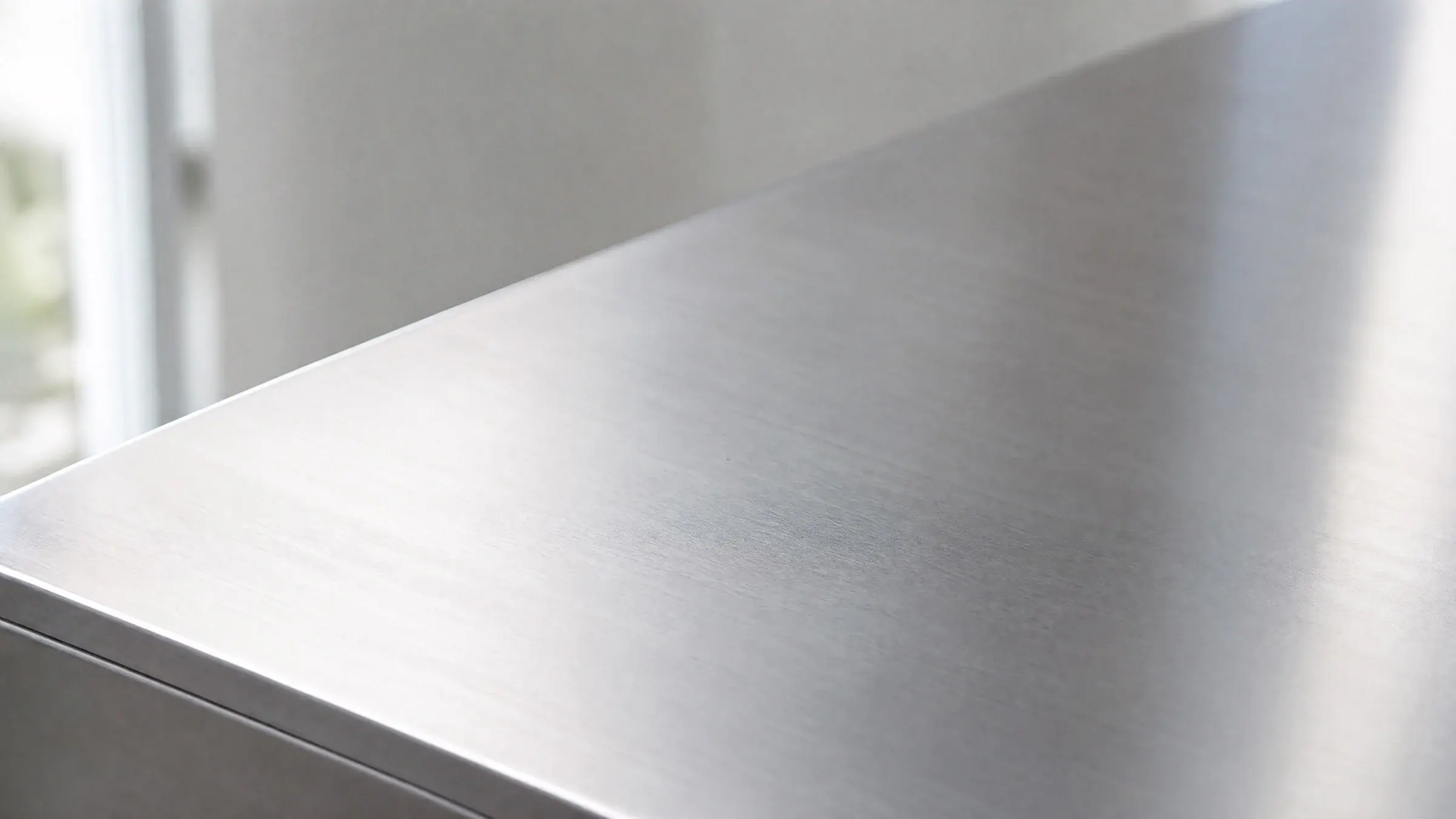 Brushed 2205 stainless steel surface in soft natural light