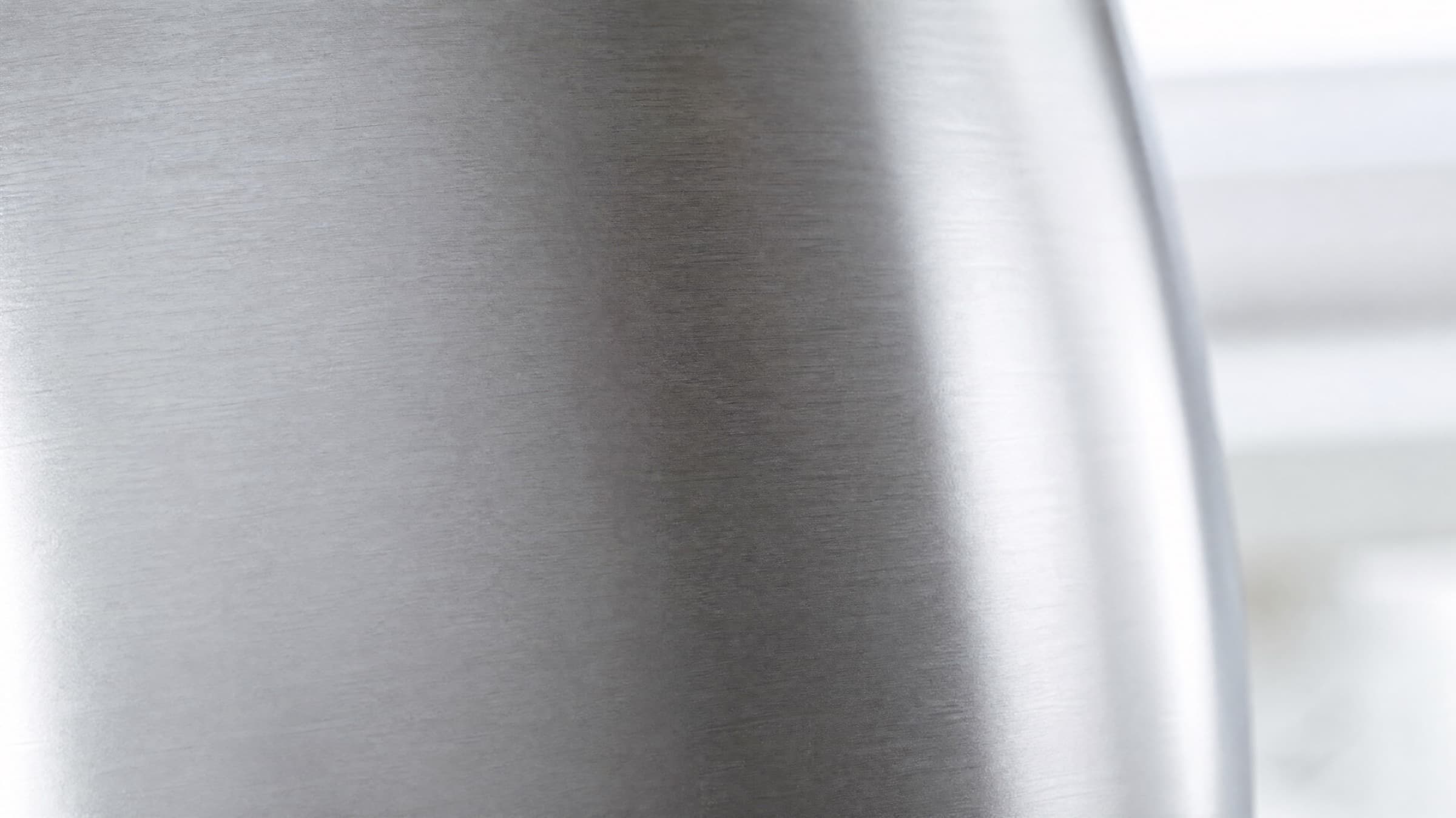 Brushed 2304 stainless steel surface in soft natural light