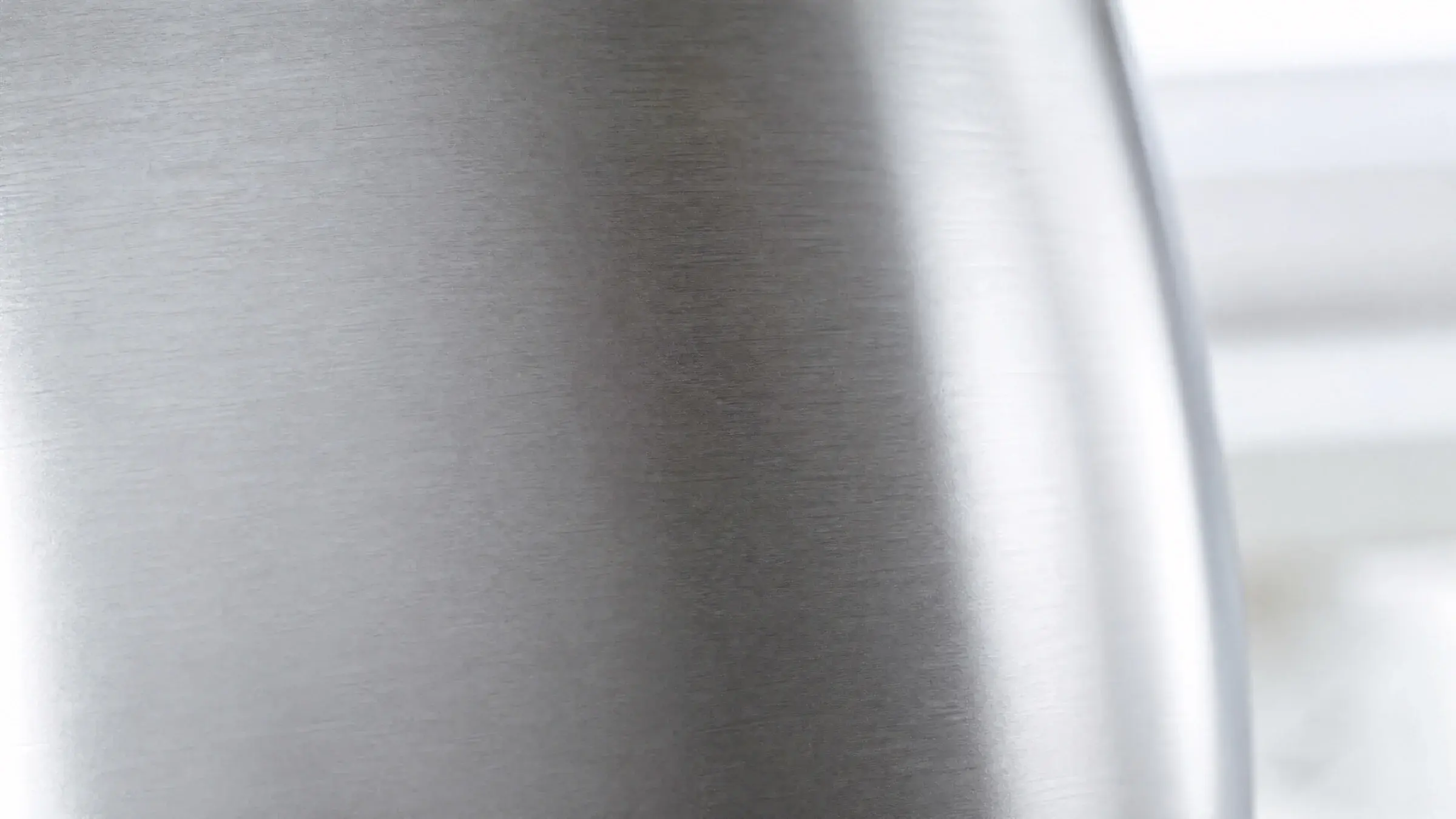 Brushed 2304 stainless steel surface in soft natural light
