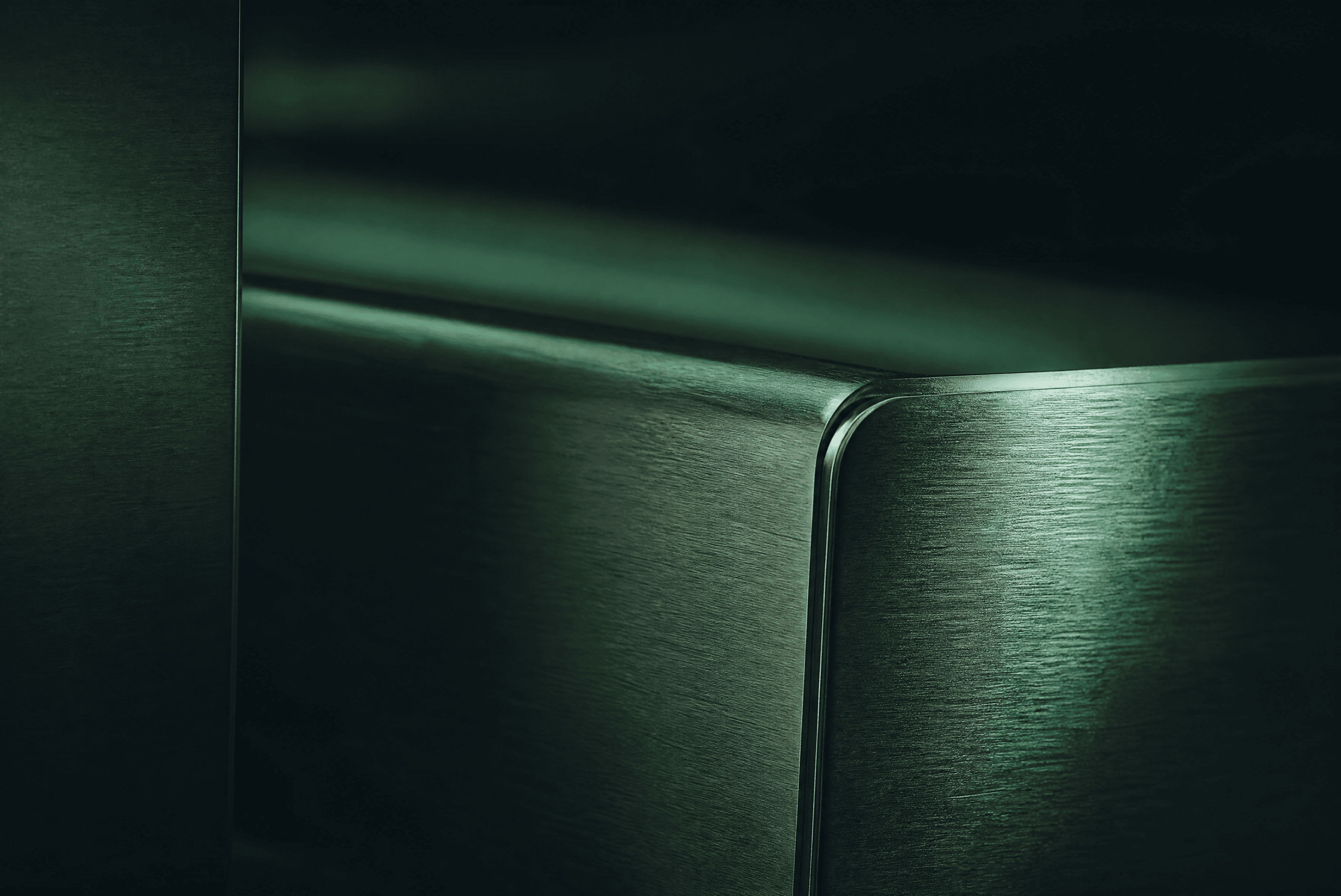 Brushed 304 stainless steel surface in a deep-green industrial setting