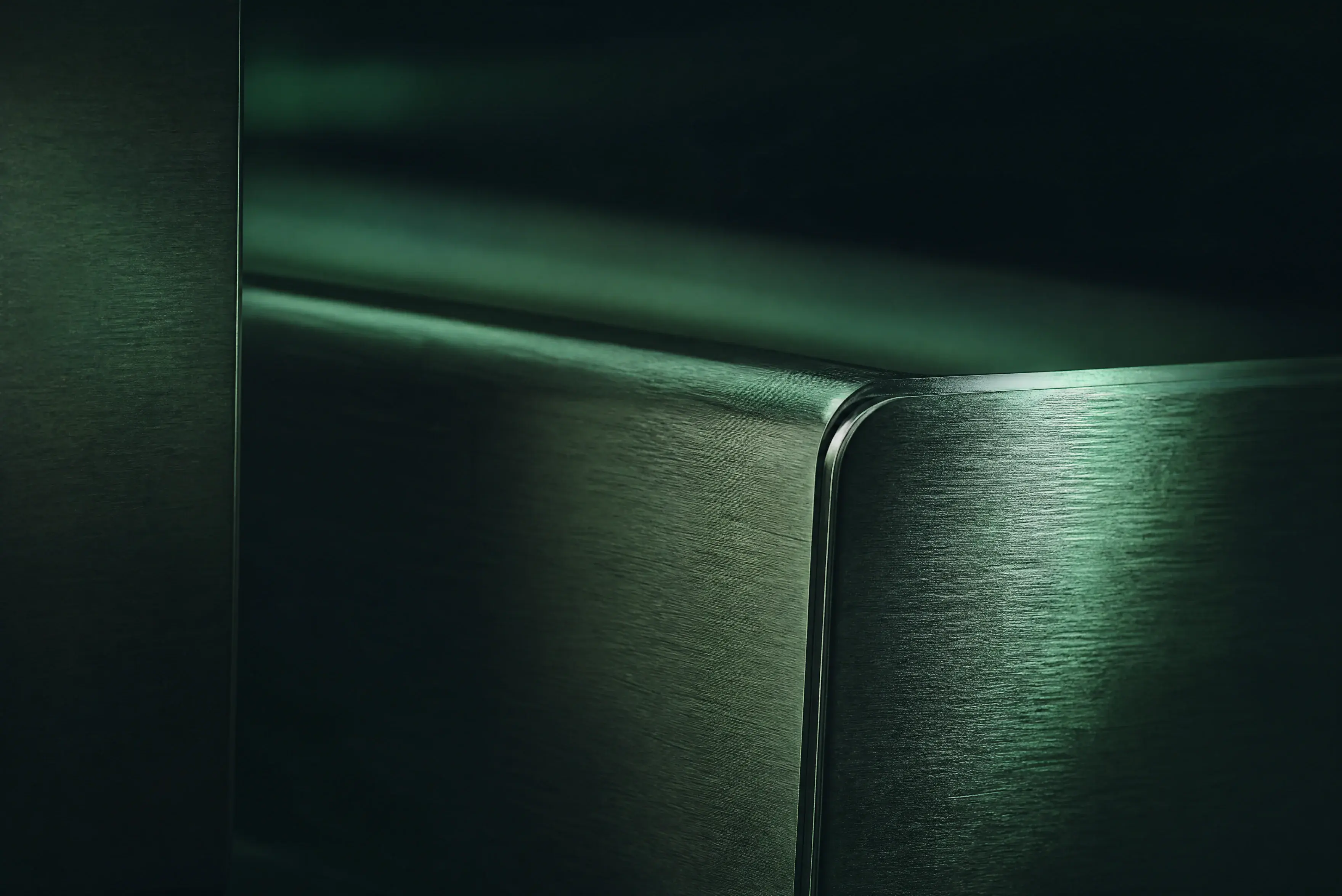 Brushed 304 stainless steel surface in a deep-green industrial setting