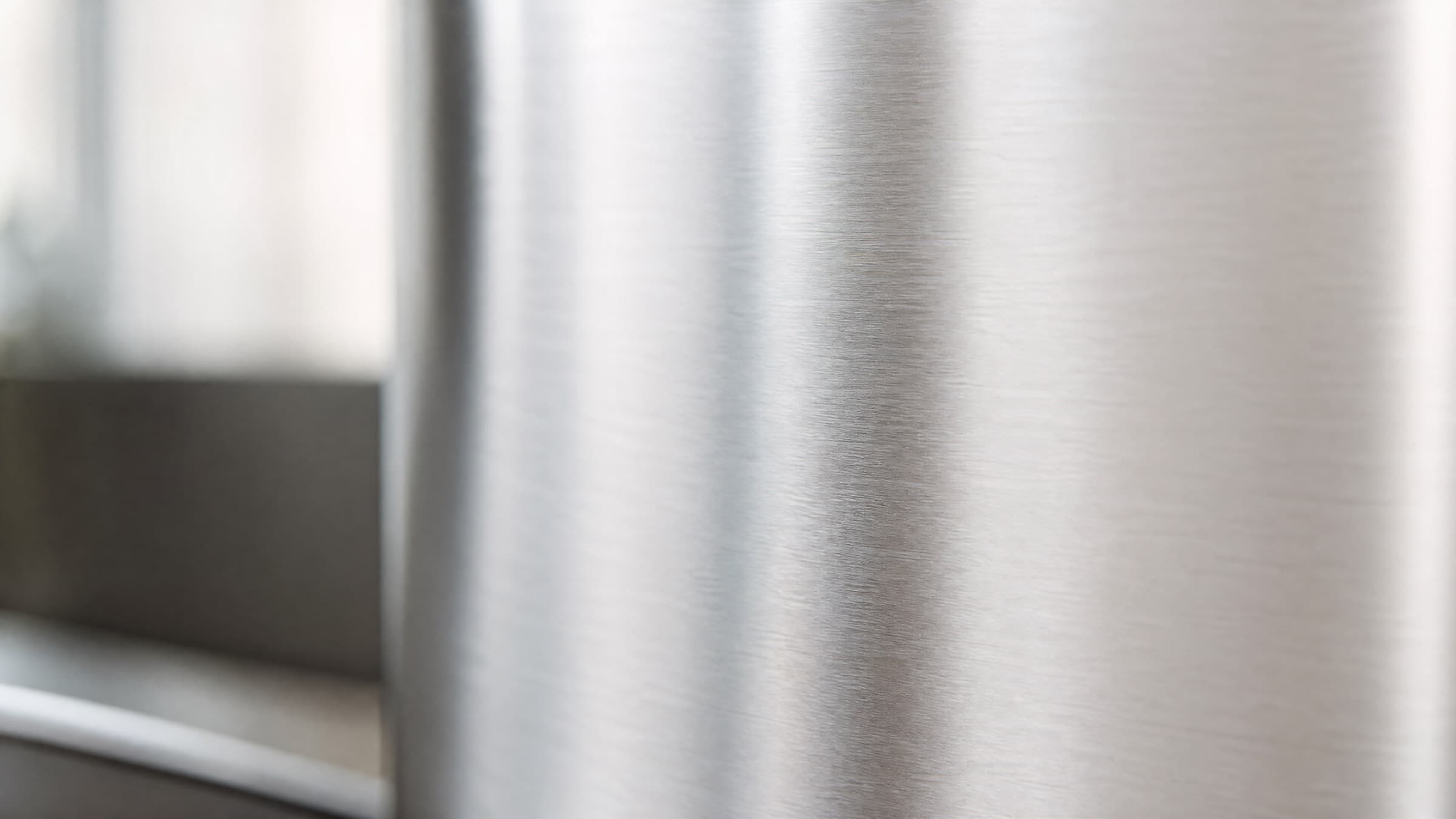 Brushed 316L stainless steel surface in soft natural light