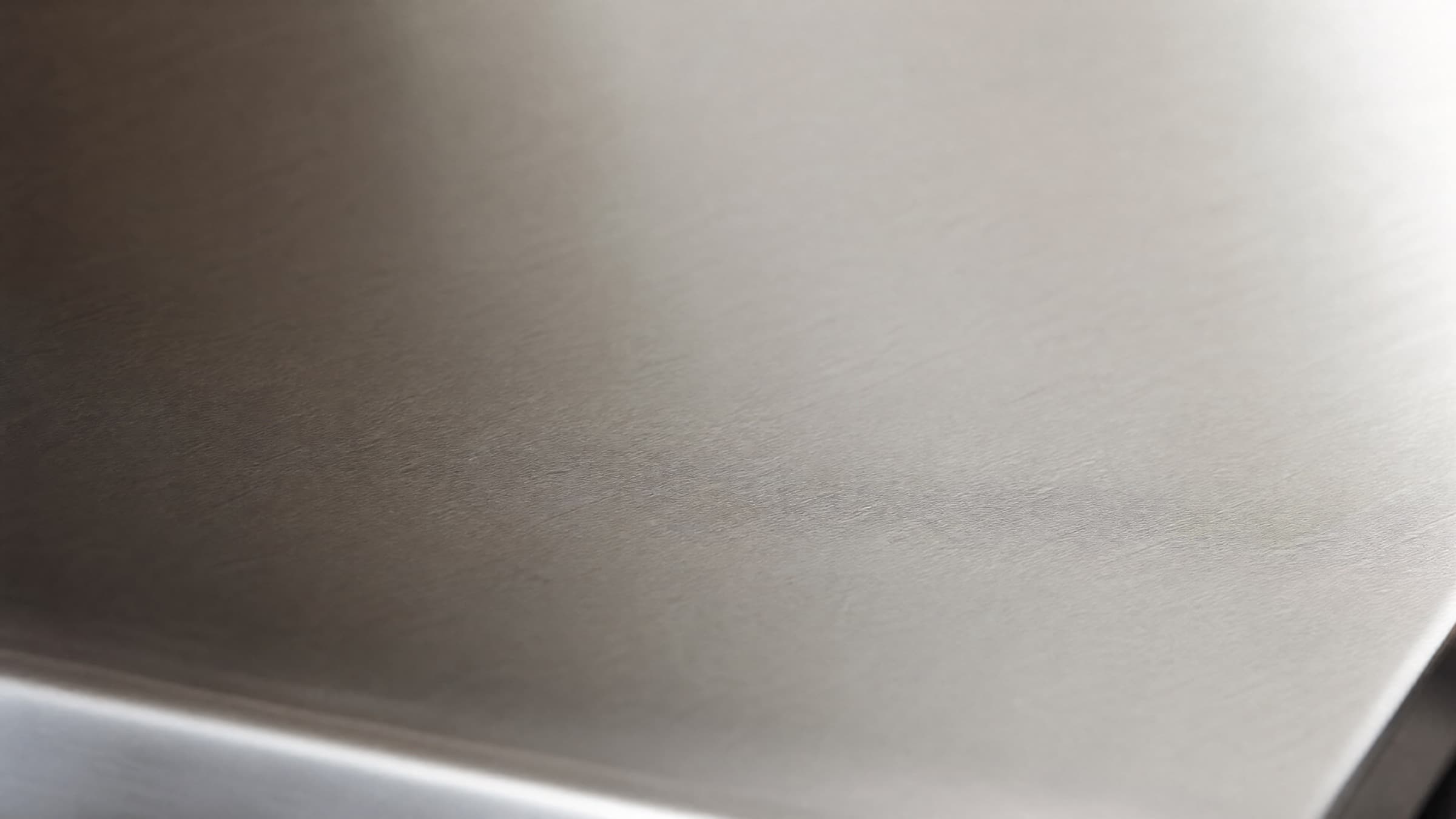 Brushed 3CR13 stainless steel surface in soft natural light