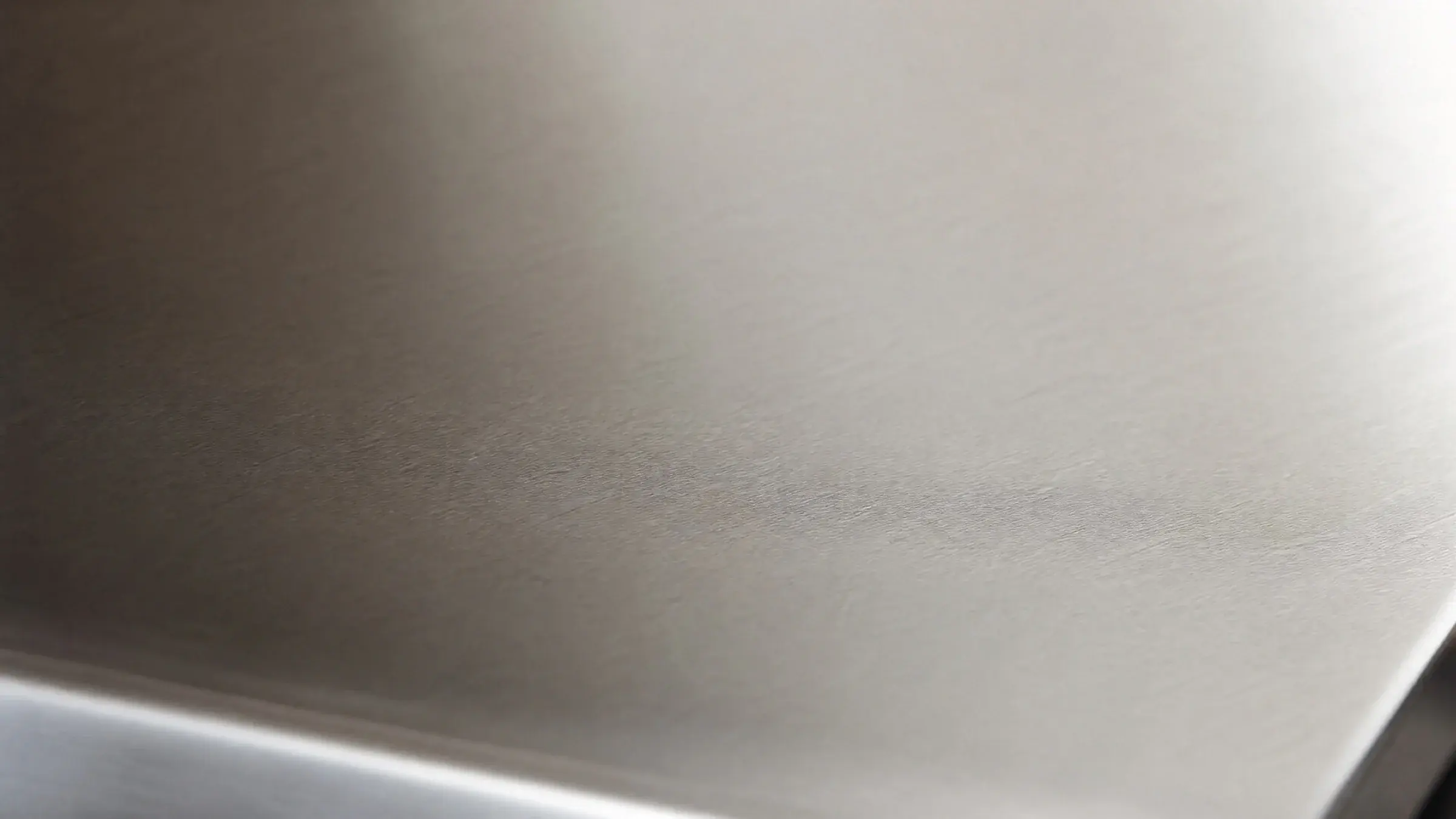 Brushed 3CR13 stainless steel surface in soft natural light