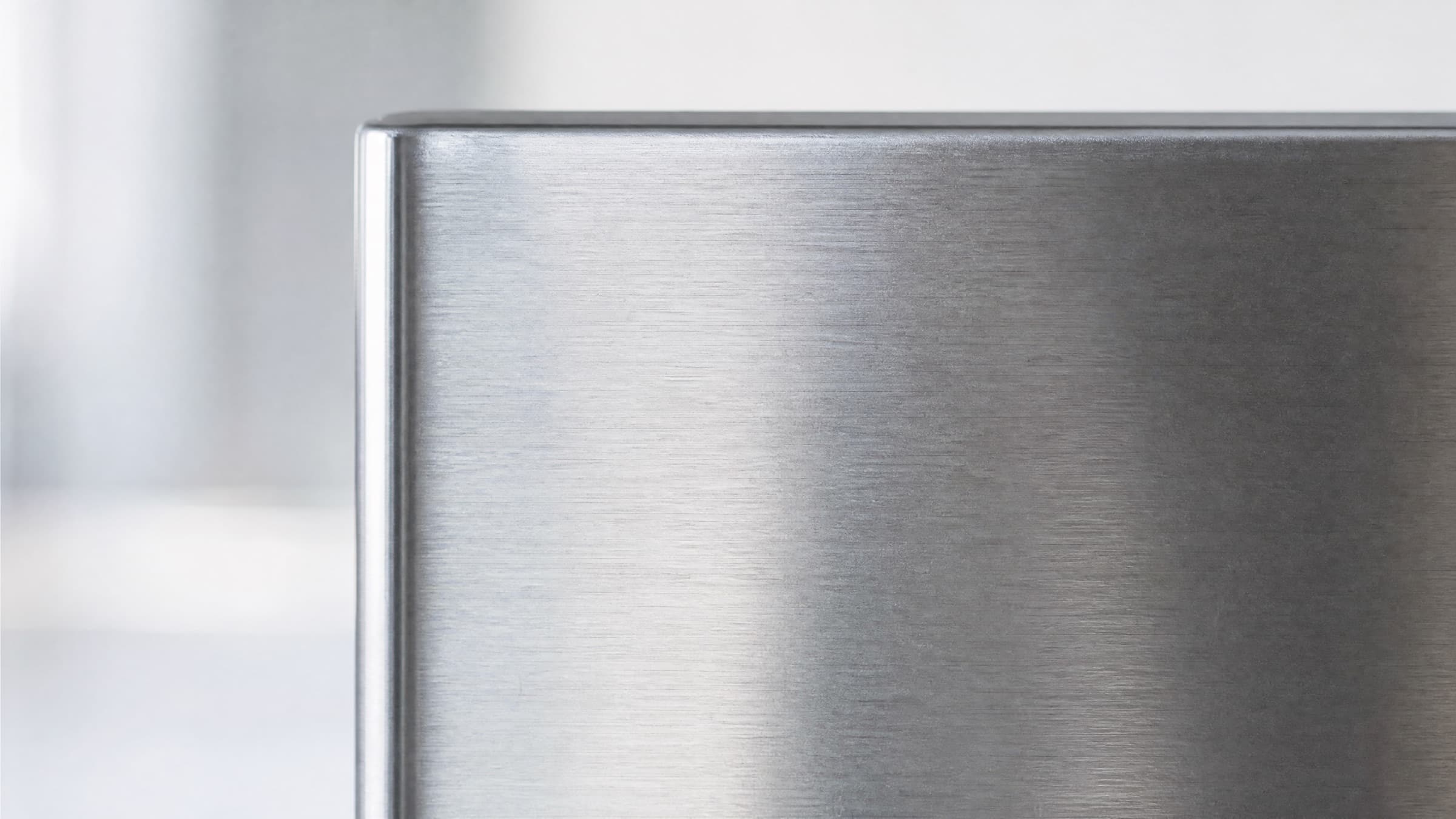 Brushed 410 stainless steel surface in soft natural light
