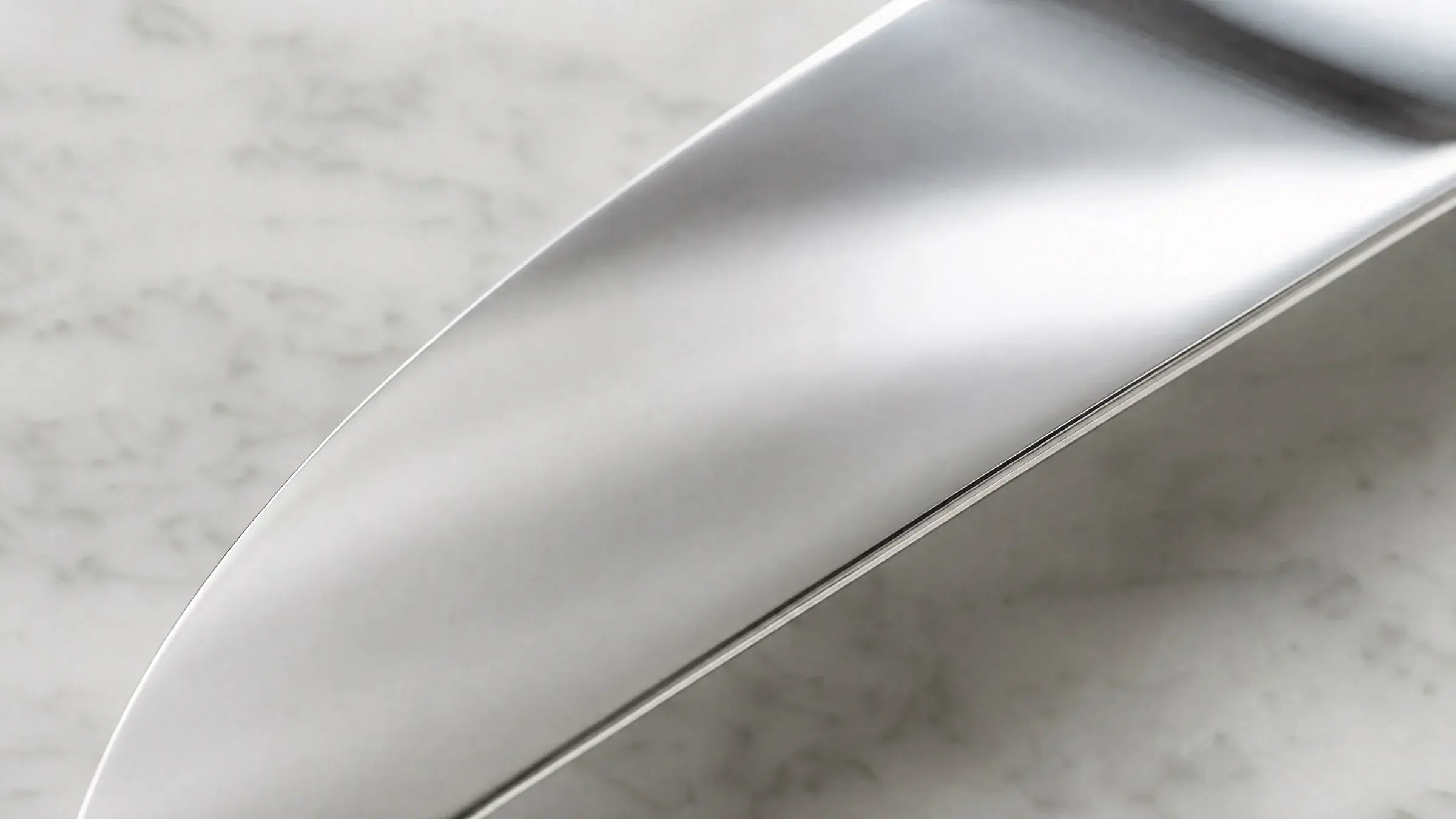 Brushed 420 stainless steel surface in soft natural light