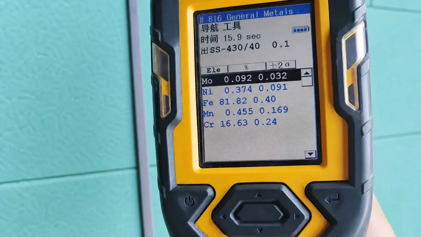 Portable alloy spectrometer display showing a 430 stainless steel readout — about 16.6% chromium and no nickel.