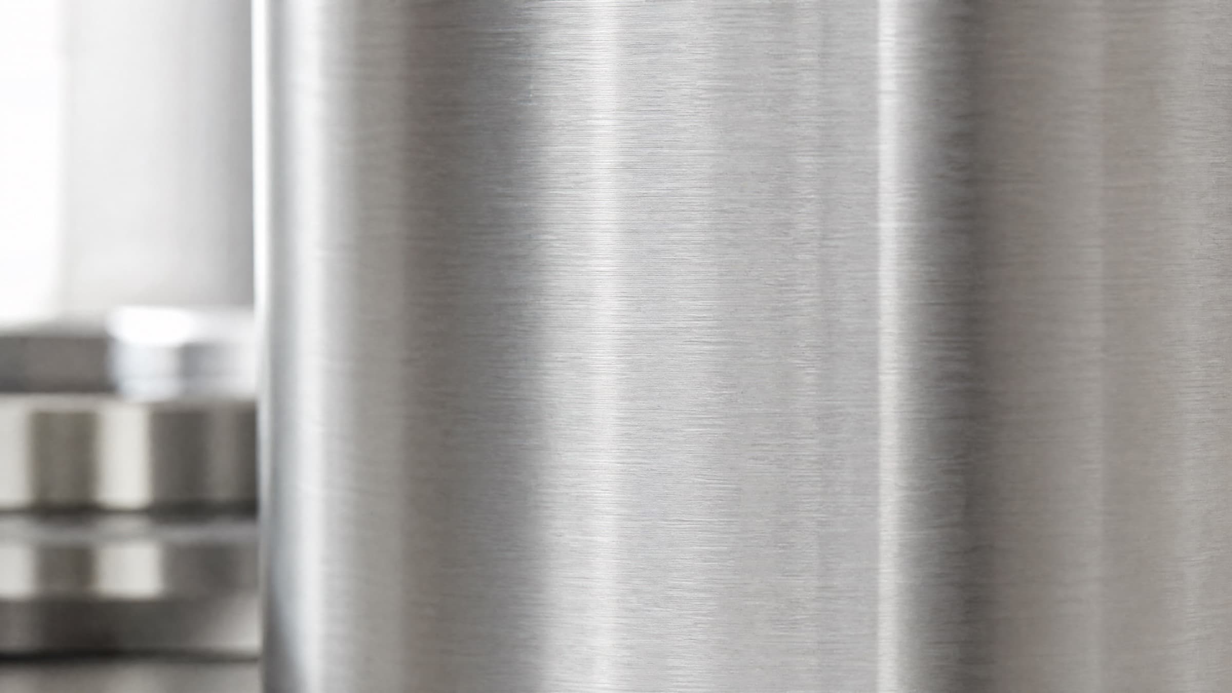 Brushed 444 stainless steel surface in soft natural light