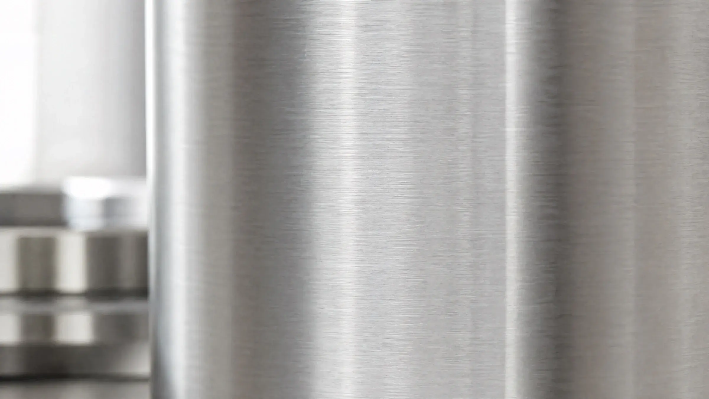 Brushed 444 stainless steel surface in soft natural light