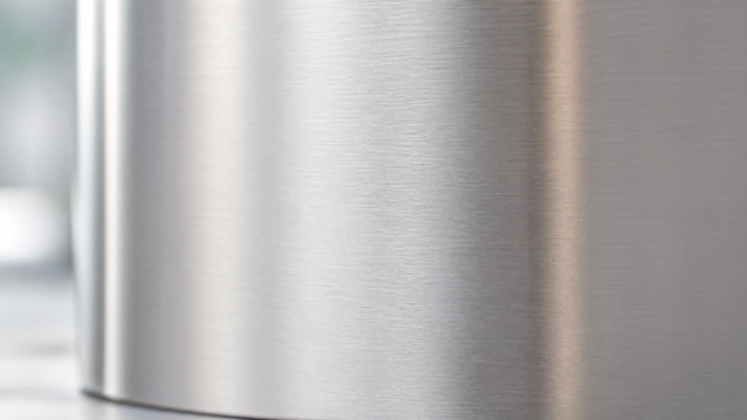 Brushed 4CR13 stainless steel surface in soft natural light