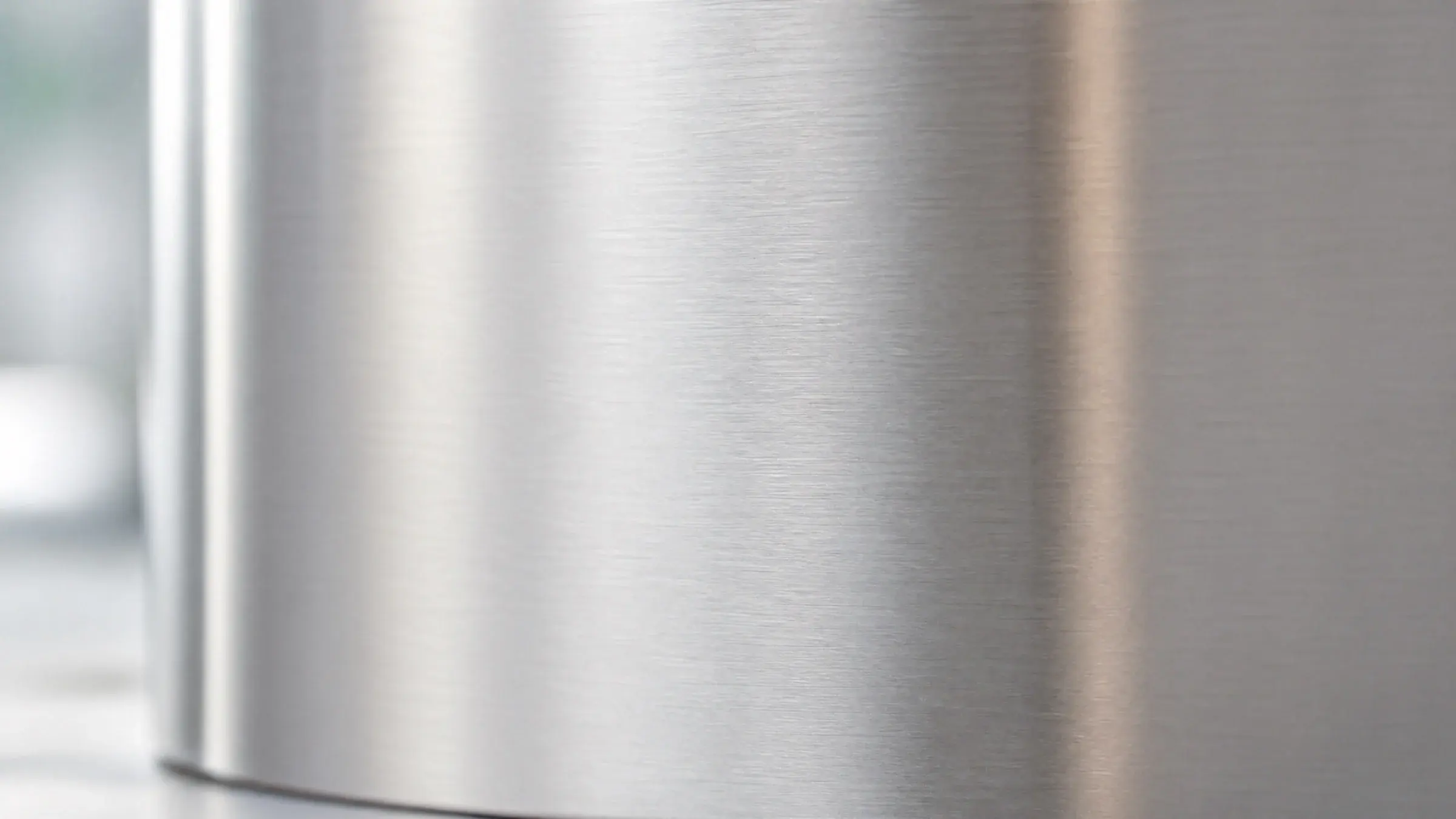 Brushed 4CR13 stainless steel surface in soft natural light