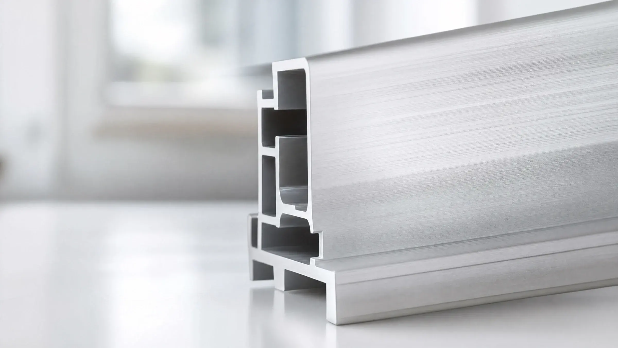 Brushed 6063 aluminium surface in soft natural light