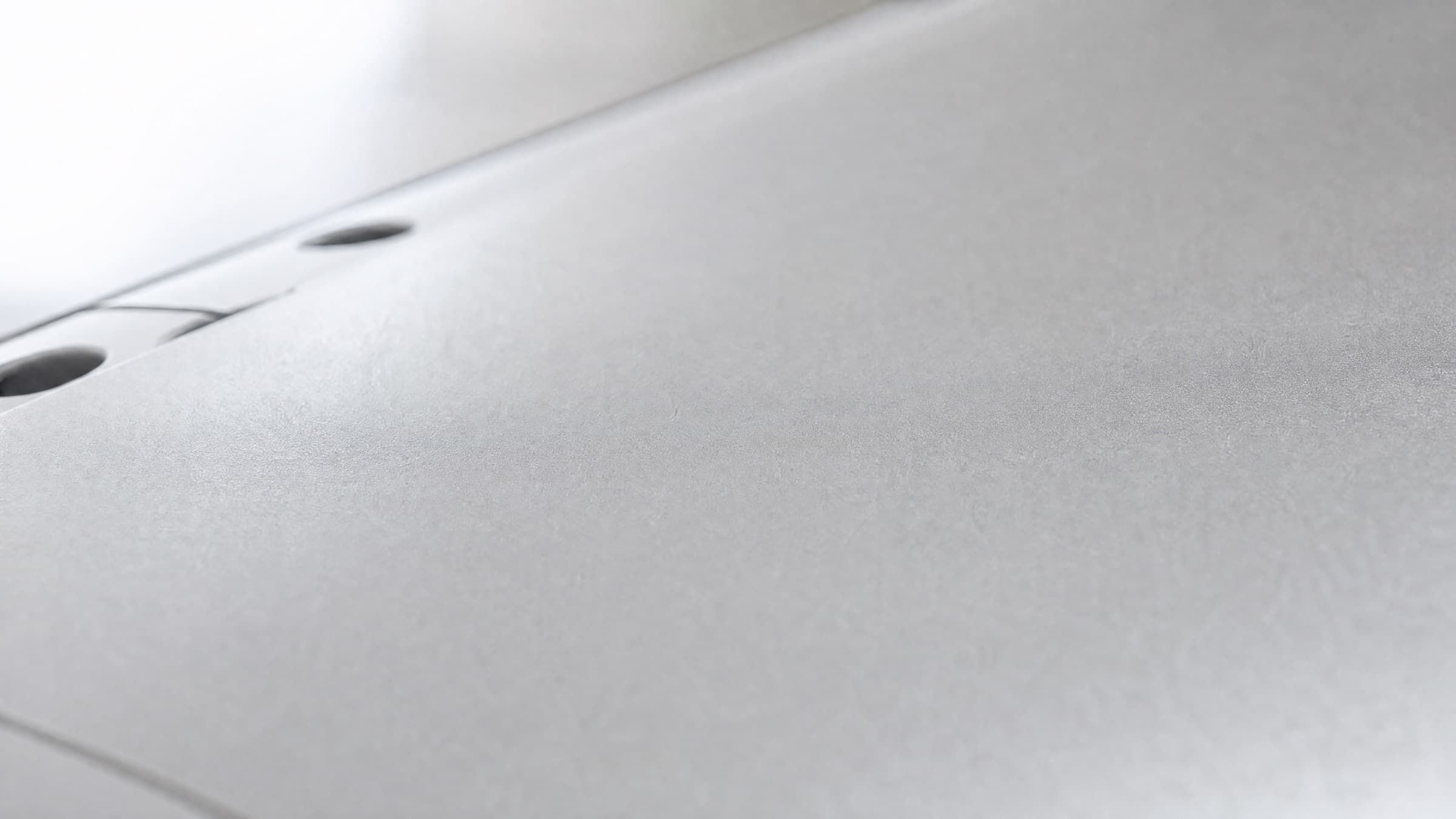 Brushed 7075 aluminium surface in soft natural light