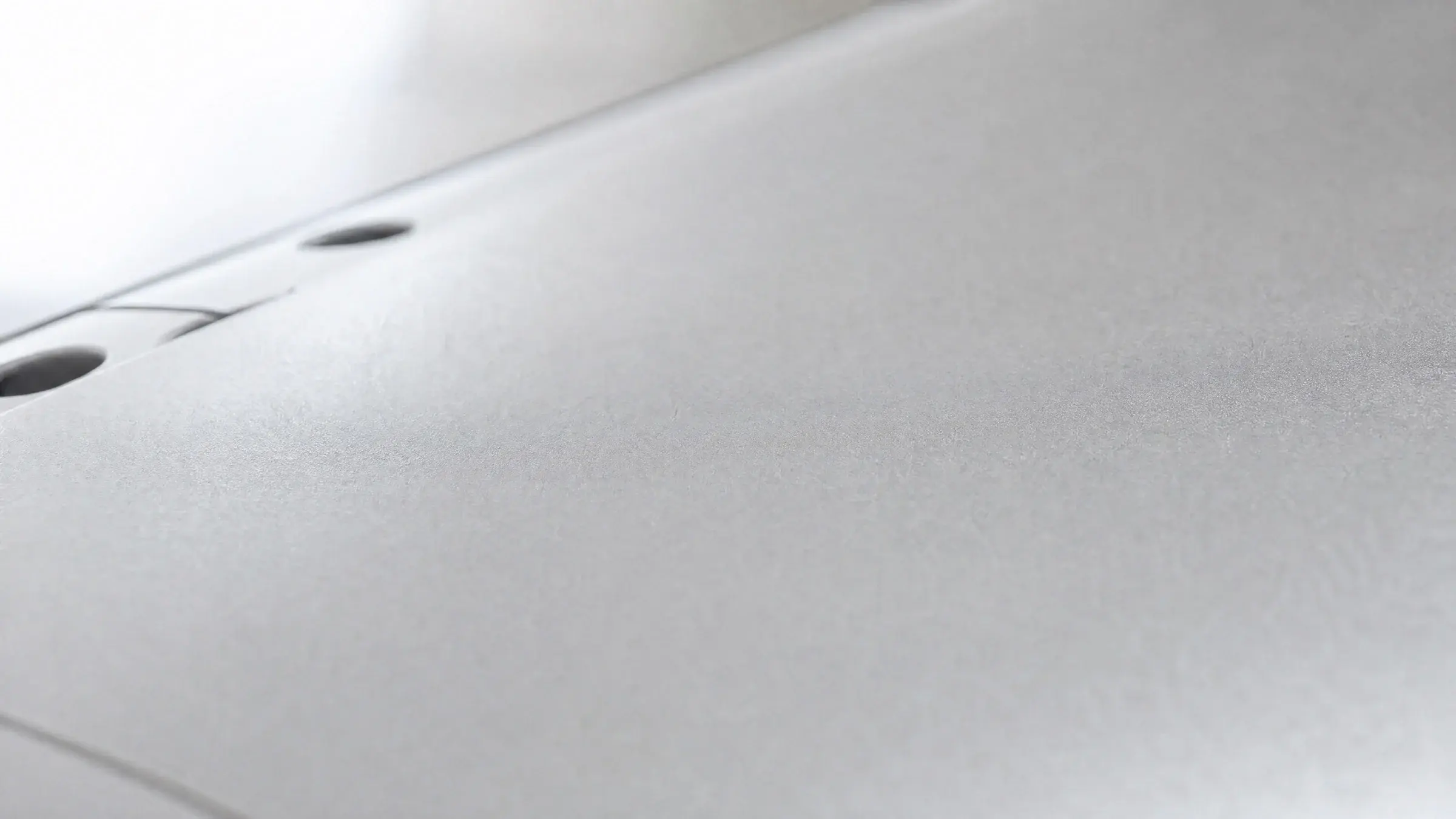 Brushed 7075 aluminium surface in soft natural light