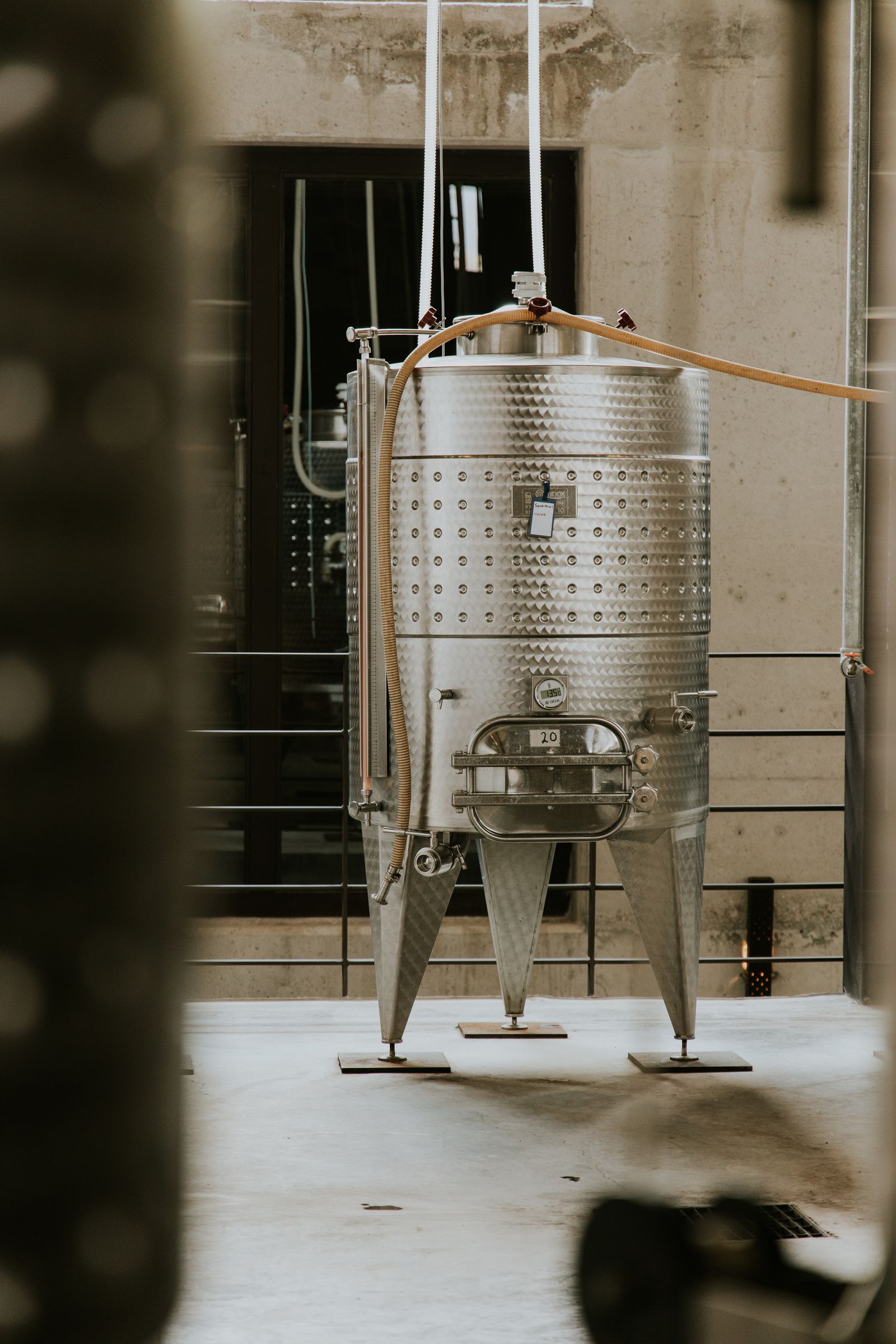 Large stainless steel process tank in an industrial setting